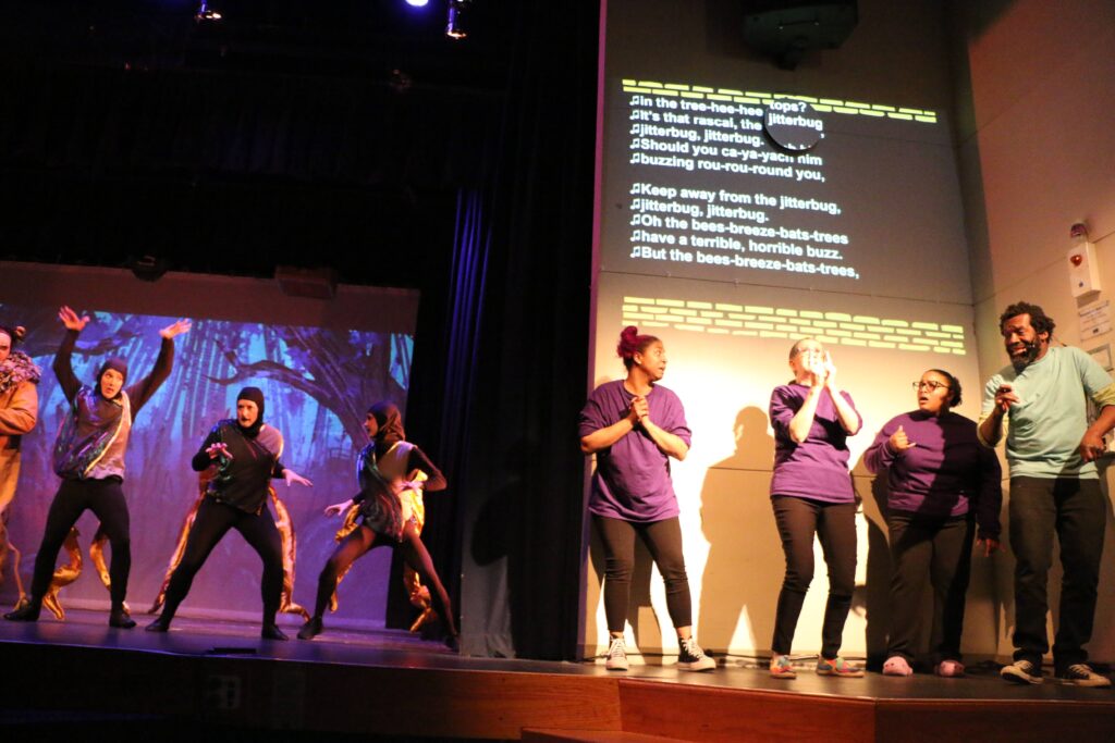 Jitterbugs dancing and Vox interpreting team signing, with captions projected them.