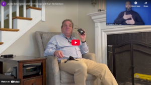 thumbnail of Audio Description and Technology with Carl Richardson featuring Carl sitting in his living room holding an AD/ALD receiver and an ASL interpreter in the top right corner.