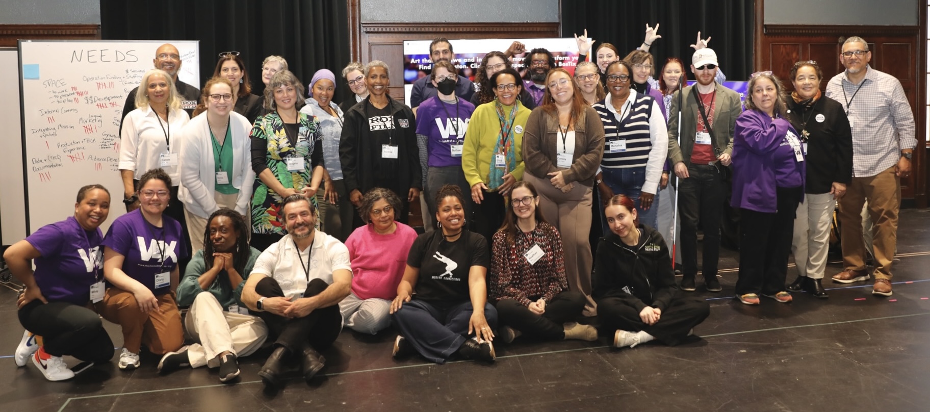 a large, diverse group photo of 32 VOX n’ ROX CARE Fair participants and facilitators smiling.